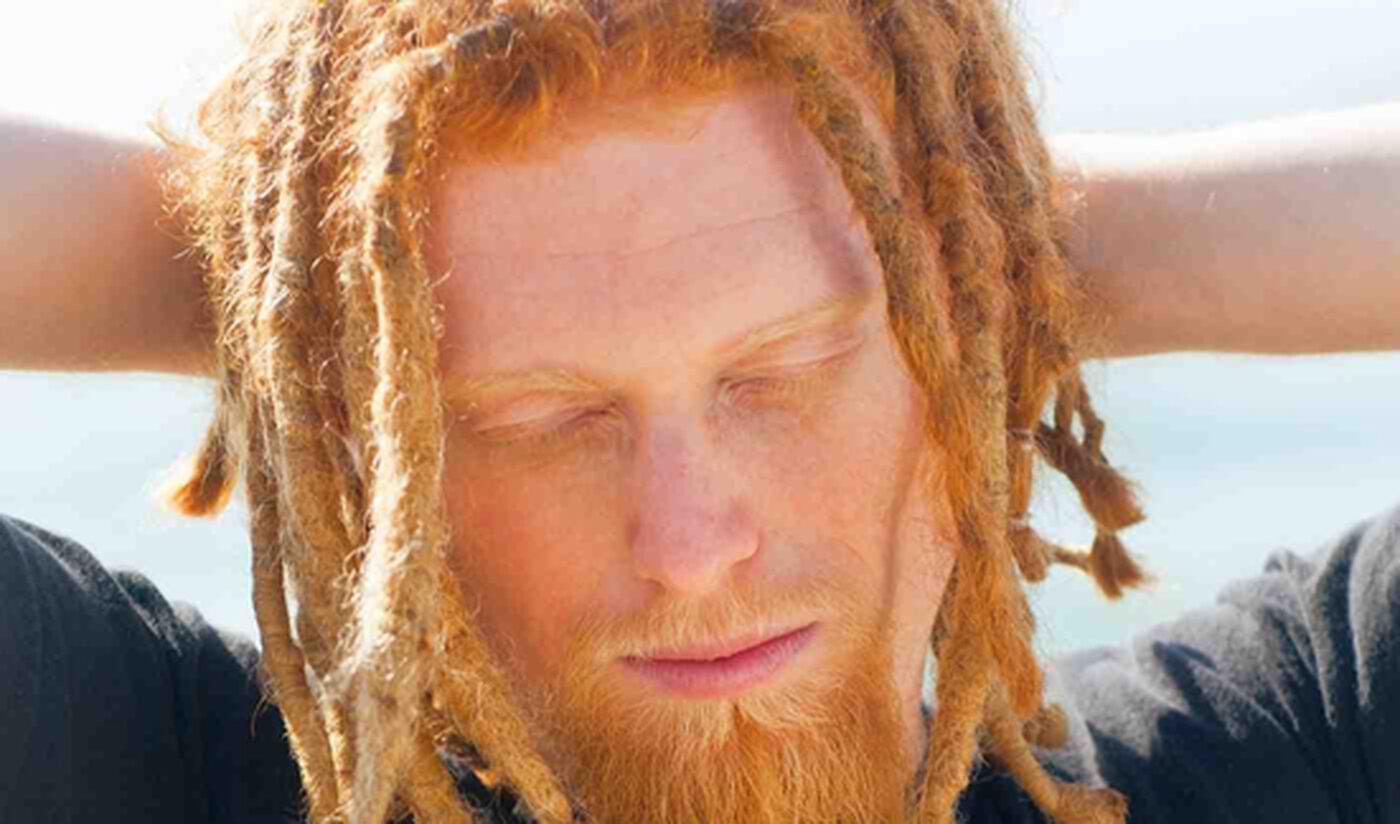 Hipster with horrifying ginger dreadlocks.